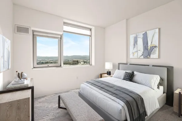 a bedroom with a bed and a window