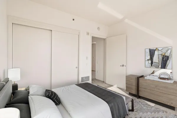 a spacious bedroom with a bed and a couch