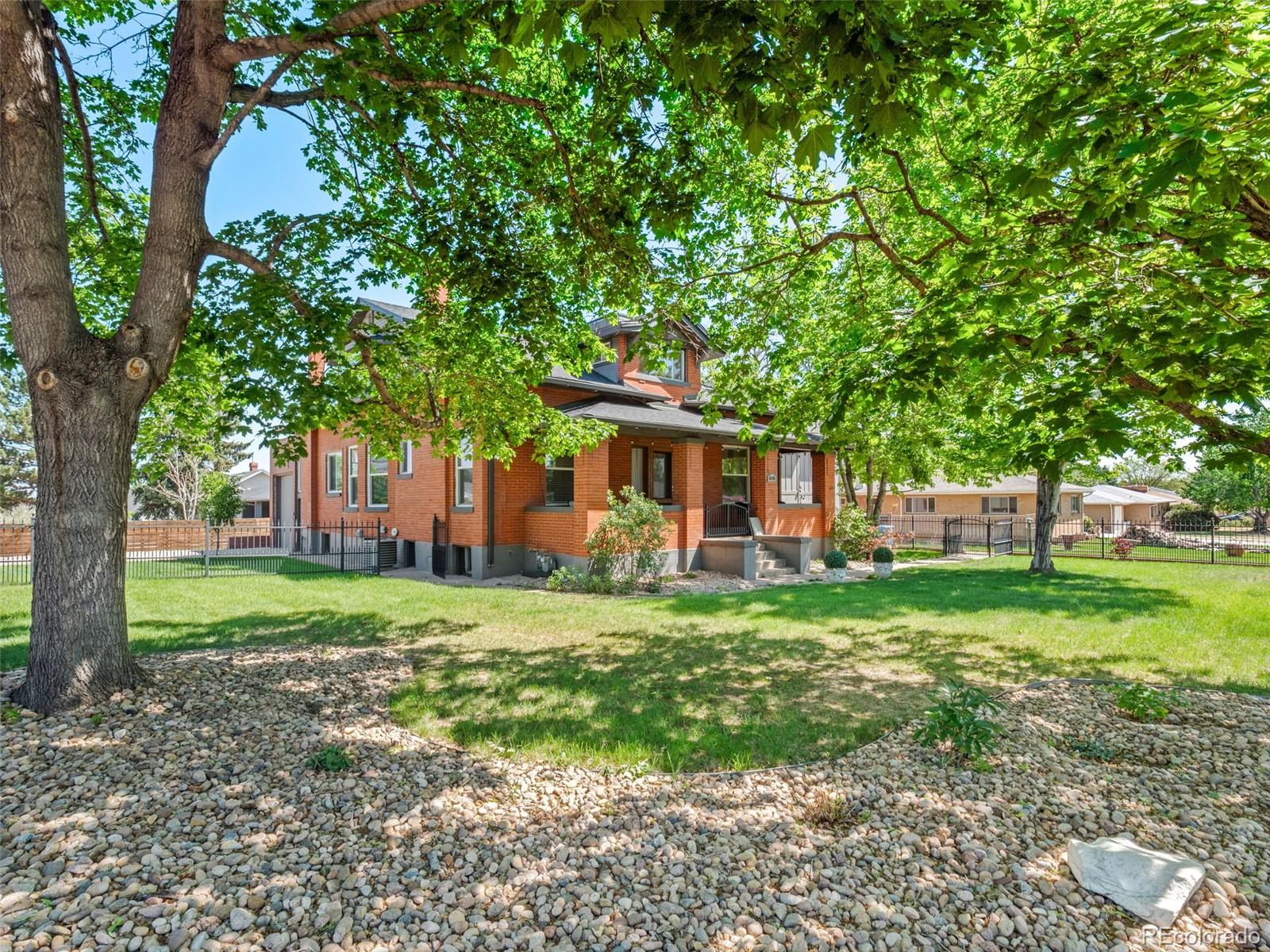 6595 West 46th Place Wheat Ridge, CO 80033 - Photo 42 of 48 a front view of a house with a yard