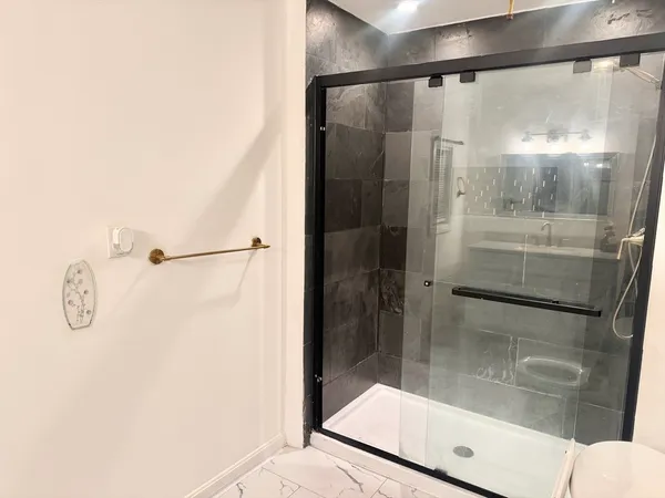 a bathroom with a shower and mirror