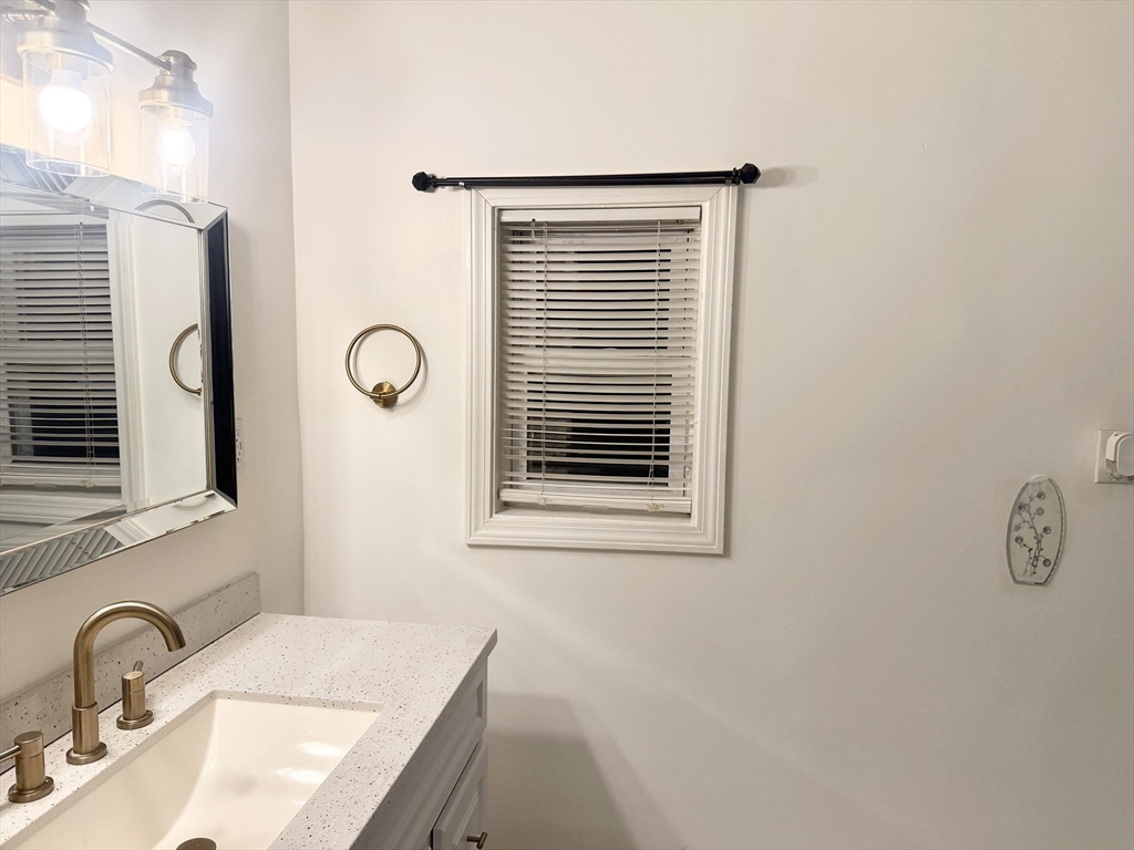 14 Addison Avenue, Unit 2 Brockton, MA 02302 - Photo 6 of 7 a bathroom with a sink and a mirror