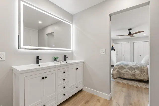 a bathroom with a granite countertop sink and a mirror