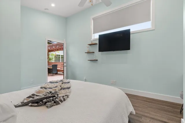 a bedroom with a bed and flat screen tv