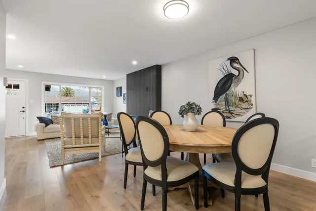 a dining room with furniture and wooden floor