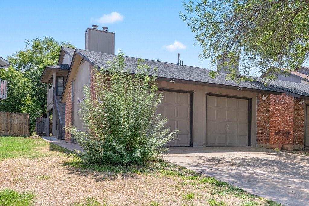 1803 Rawhide Drive Round Rock, TX 78681 - Photo 1 of 1 a front view of a house with garden