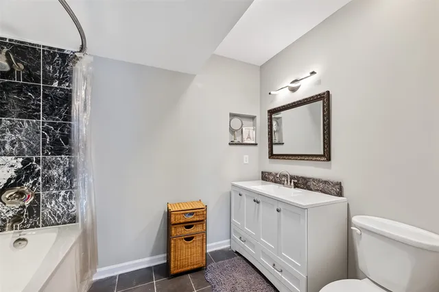 a bathroom with a toilet a sink and a mirror