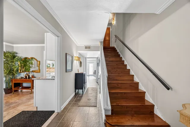 a view of entryway and hall with wooden floor