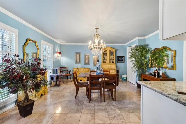 a view of a dining room with furniture and chandelier