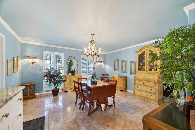 a view of a dining room with furniture and chandelier