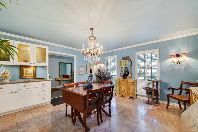 a view of a dining room with furniture and a chandelier
