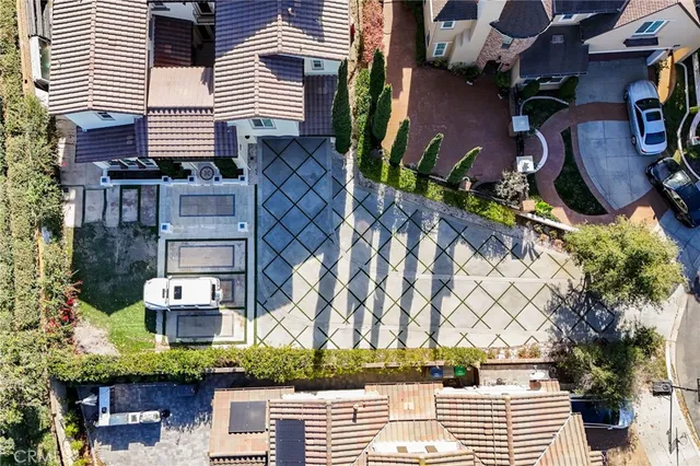 a view of a yard with cars on road