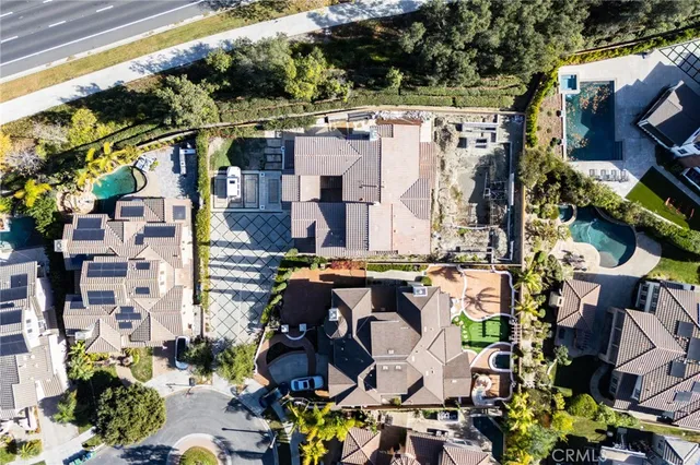 an aerial view of house with yard and mountain view in back