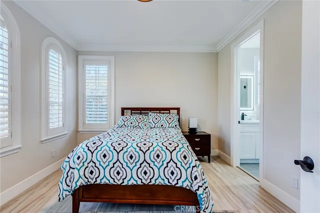a living room with furniture a flat screen tv and a floor to ceiling window