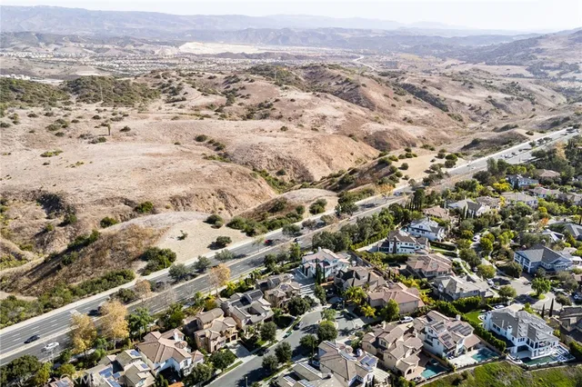 an aerial view of multiple houses with yard