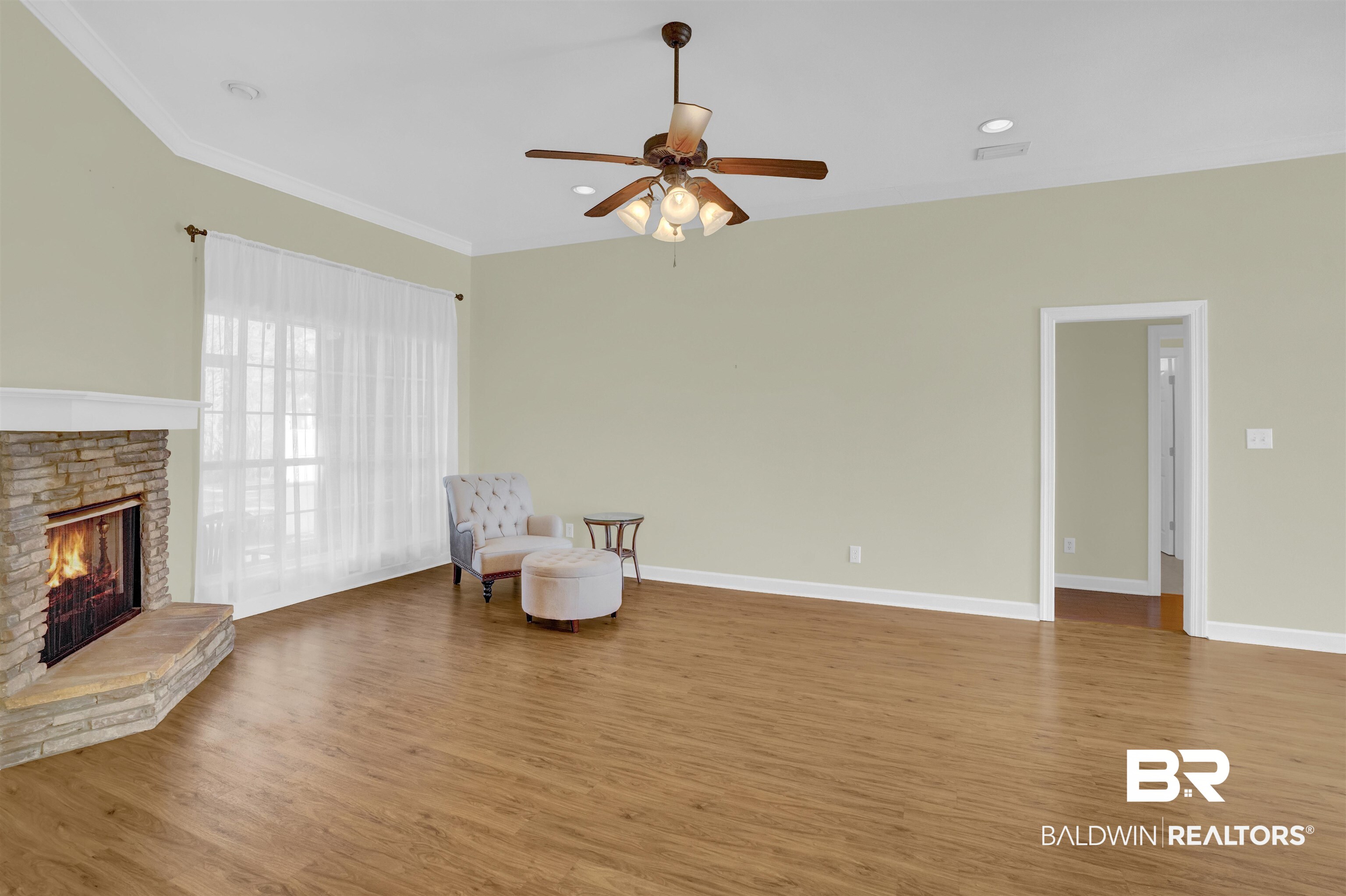 100 Conti Court Fairhope, AL 36532 - Photo 18 of 54 Sitting room featuring crown molding, ceiling fan, a fireplace, and hardwood / wood-style floors