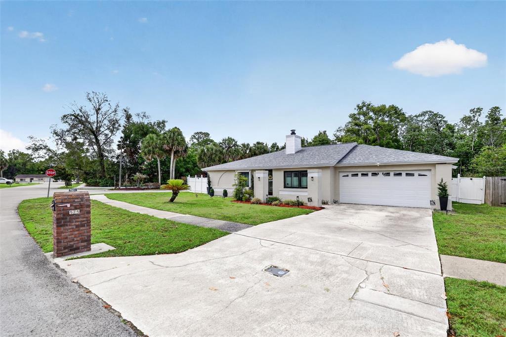 575 Tiberon Cove Road Longwood, FL 32750 - Photo 4 of 56 a front view of a house with a yard and trees