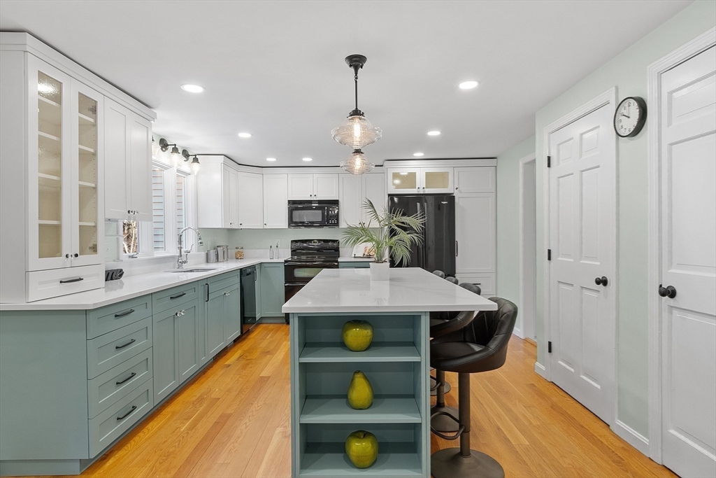 14 October Lane Stow, MA 01775 - Photo 13 of 41 a kitchen with stainless steel appliances granite countertop a sink a stove and cabinets