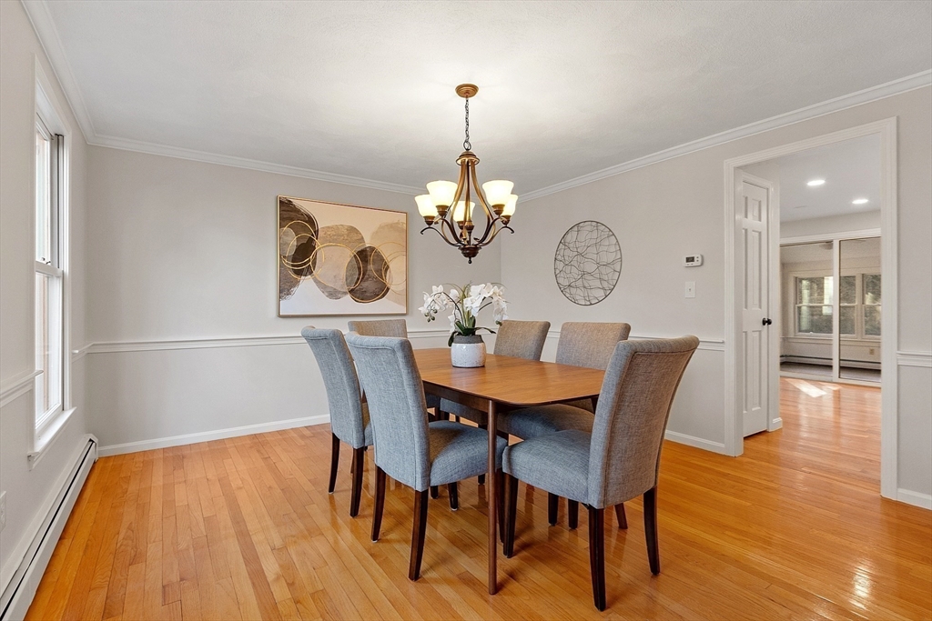 14 October Lane Stow, MA 01775 - Photo 20 of 41 a dining room with furniture a chandelier and wooden floor