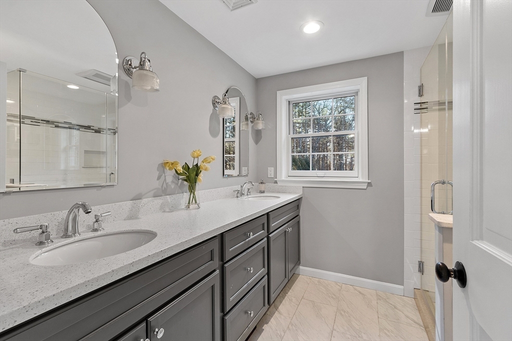 14 October Lane Stow, MA 01775 - Photo 23 of 41 a bathroom with a granite countertop sink a mirror and a shower