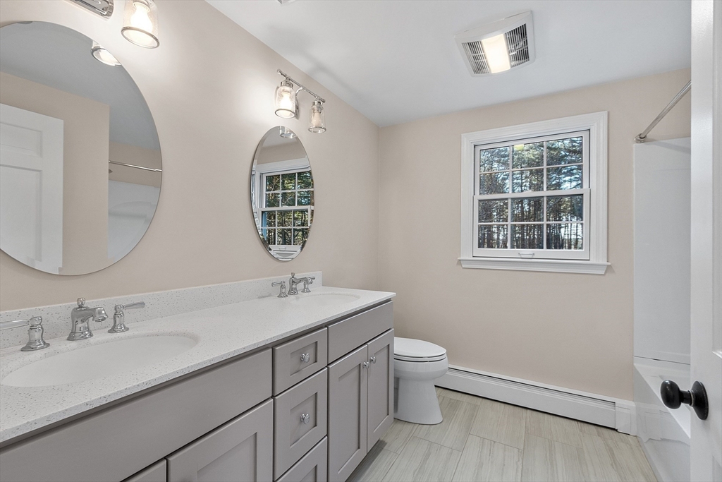 14 October Lane Stow, MA 01775 - Photo 25 of 41 a bathroom with a toilet sink and mirror