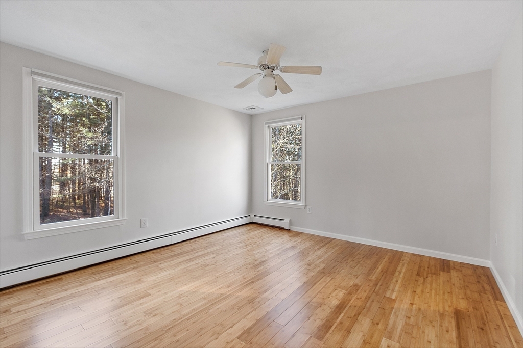 14 October Lane Stow, MA 01775 - Photo 26 of 41 a view of an empty room with a window and wooden floor