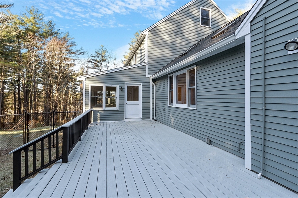 14 October Lane Stow, MA 01775 - Photo 34 of 41 a view of a house with wooden deck
