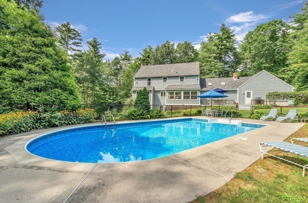 14 October Lane Stow, MA 01775 - Photo 37 of 41 a view of a swimming pool with a yard