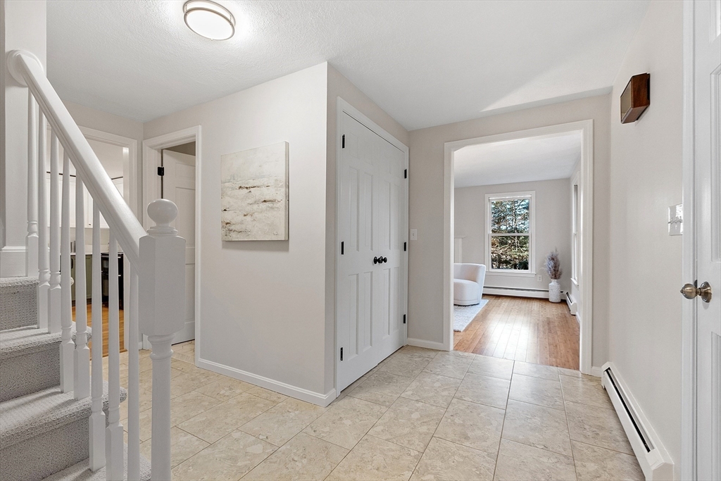 14 October Lane Stow, MA 01775 - Photo 4 of 41 a view of a hallway view with wooden floor and staircase