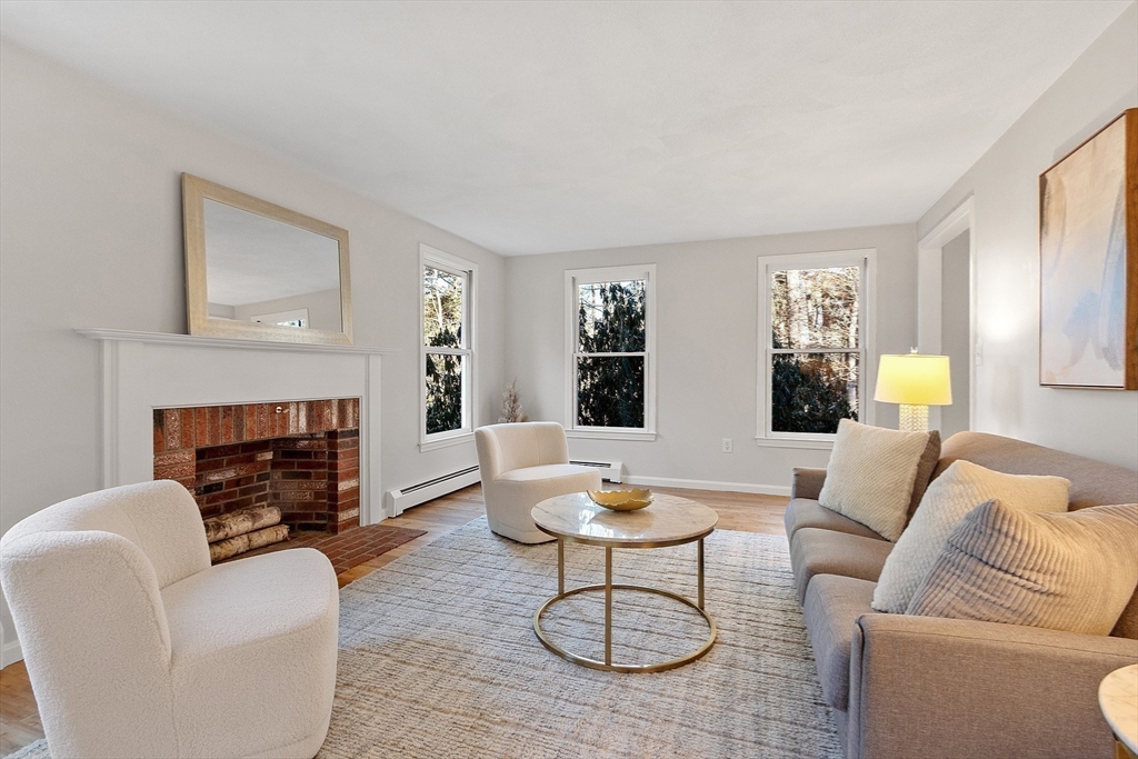 14 October Lane Stow, MA 01775 - Photo 6 of 41 a living room with furniture a fireplace and window