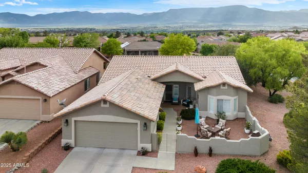 an aerial view of a house with a garden and a mountain view