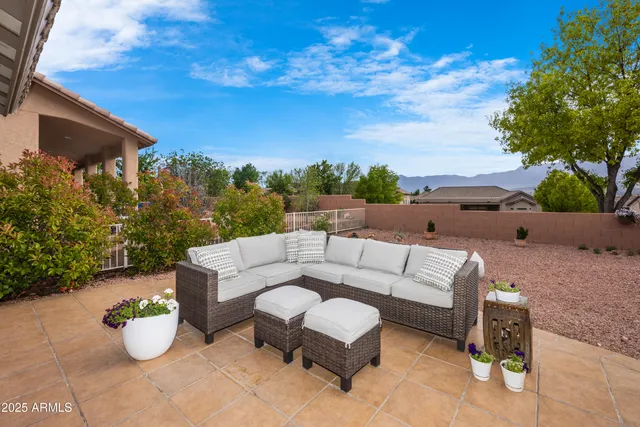a roof deck with couches and potted plants