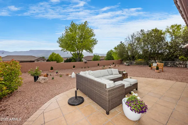 a view of a patio with couches and a table and chairs with potted plants
