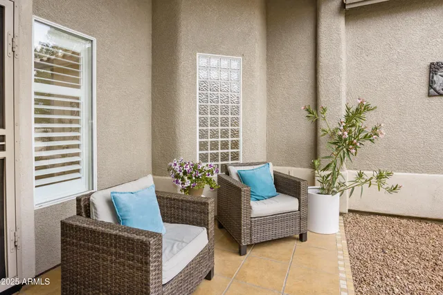 a living room with furniture and flowers