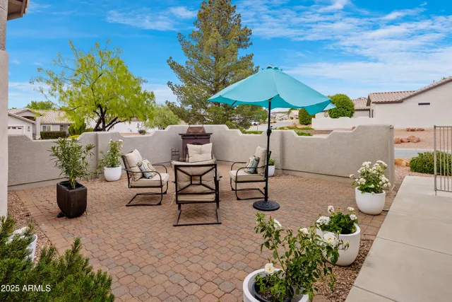 a view of a patio with plants and chairs