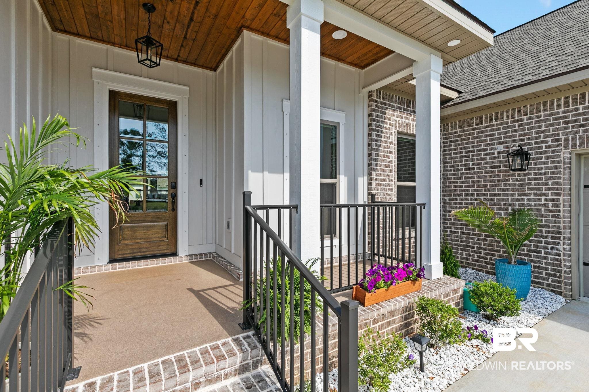 12132 Exbury Way Daphne, AL 36527 - Photo 5 of 47 Entrance to property featuring covered porch, brick siding, and a shingled roof