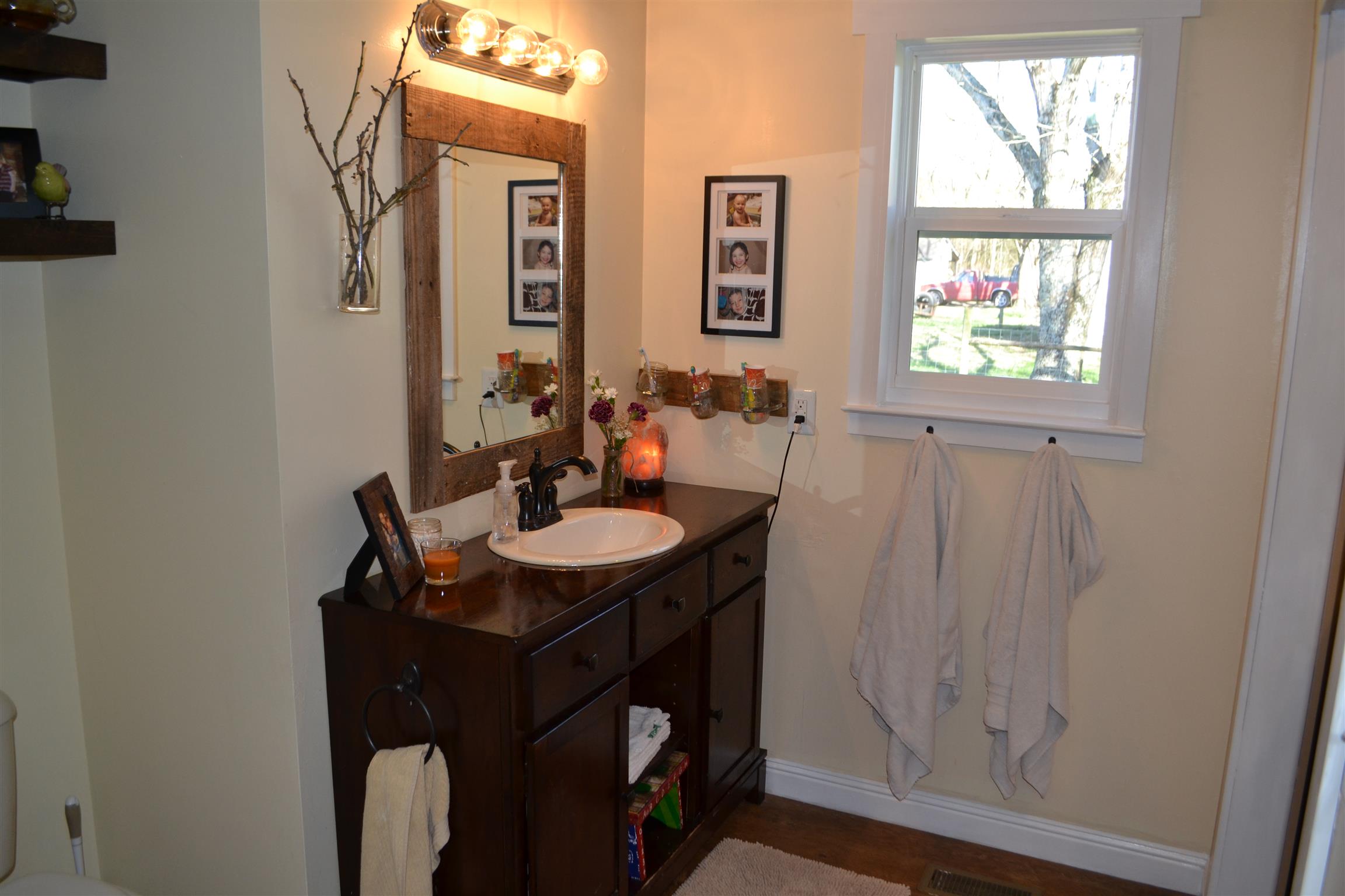 915 Hamilton Chambers Road Lebanon, TN 37087 - Photo 8 of 18 a bathroom with a sink a mirror and a window