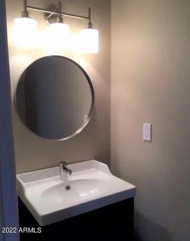 a bathroom with a sink mirror and vanity