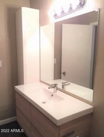 a bathroom with a sink and a mirror