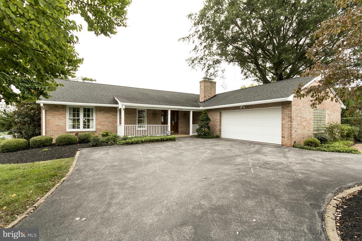 front view of a house with a yard and potted plants