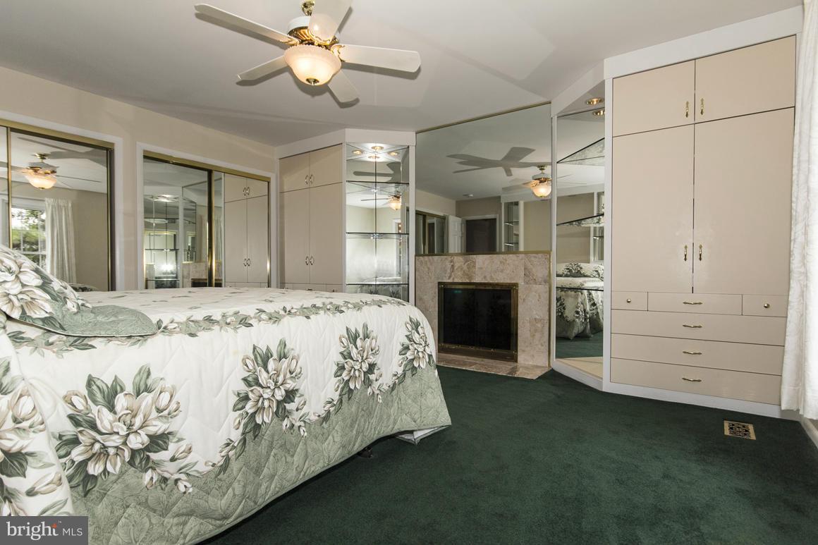 9911 Pepper Hill Road Perry Hall, MD 21128 - Photo 19 of 30 a spacious bedroom with a bed and a chandelier