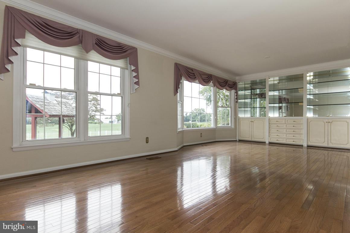 9911 Pepper Hill Road Perry Hall, MD 21128 - Photo 4 of 30 a view of an empty room with wooden floor and a window