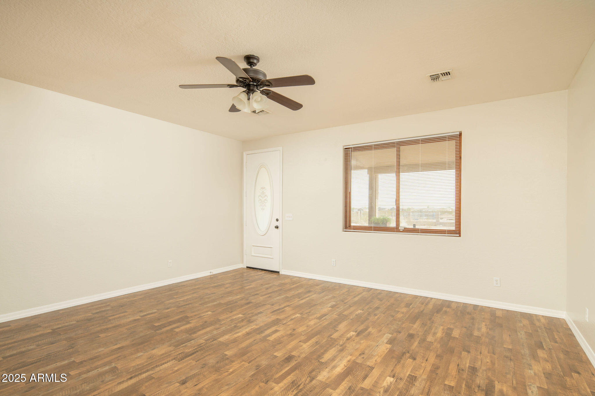 29362 North Varnum Road San Tan Valley, AZ 85143 - Photo 14 of 27 a view of a big room with wooden floor and windows in a room
