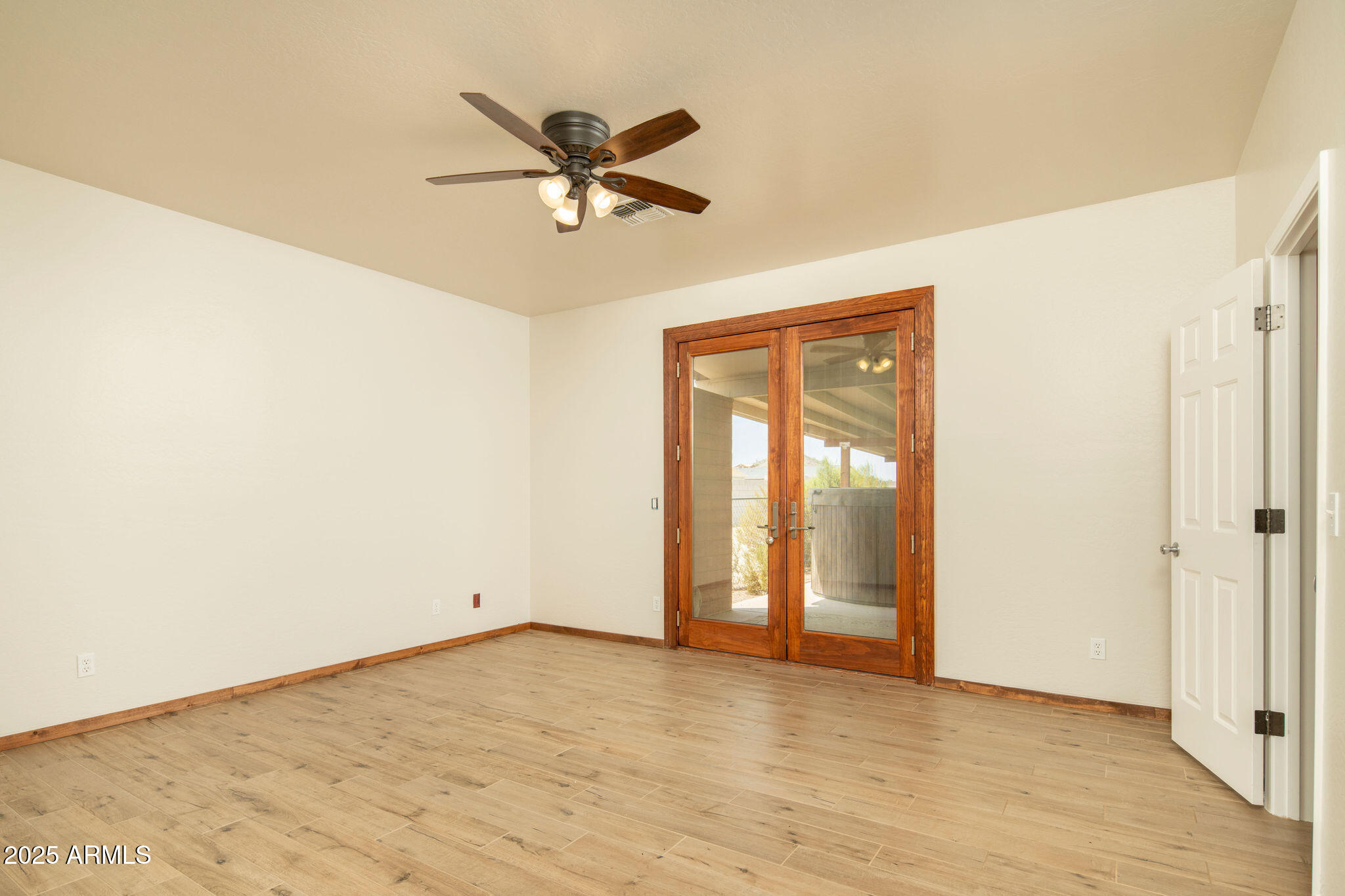29362 North Varnum Road San Tan Valley, AZ 85143 - Photo 3 of 27 a view of a room with wooden floor and a ceiling fan