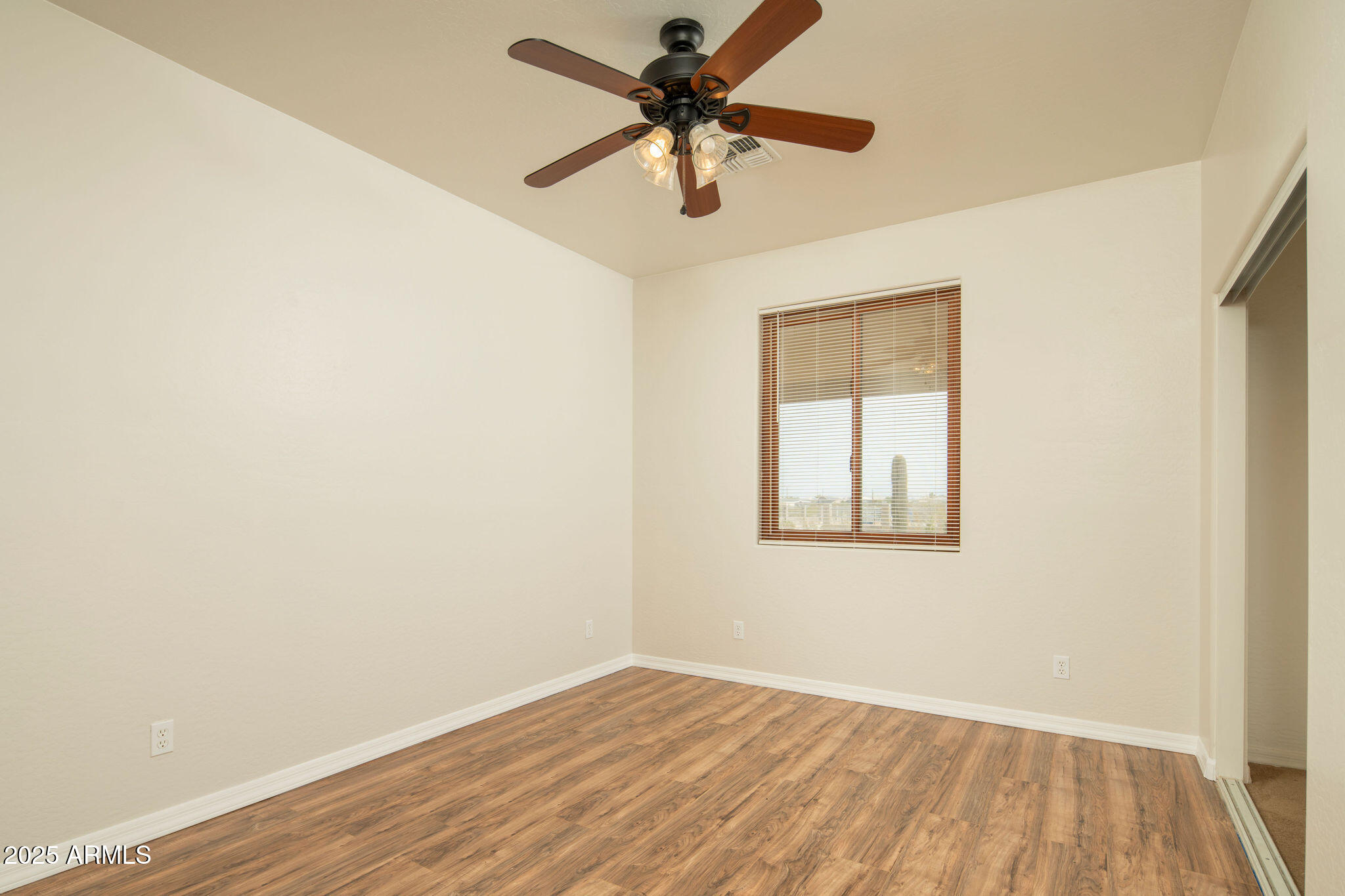 29362 North Varnum Road San Tan Valley, AZ 85143 - Photo 8 of 27 an empty room with a window and a fan
