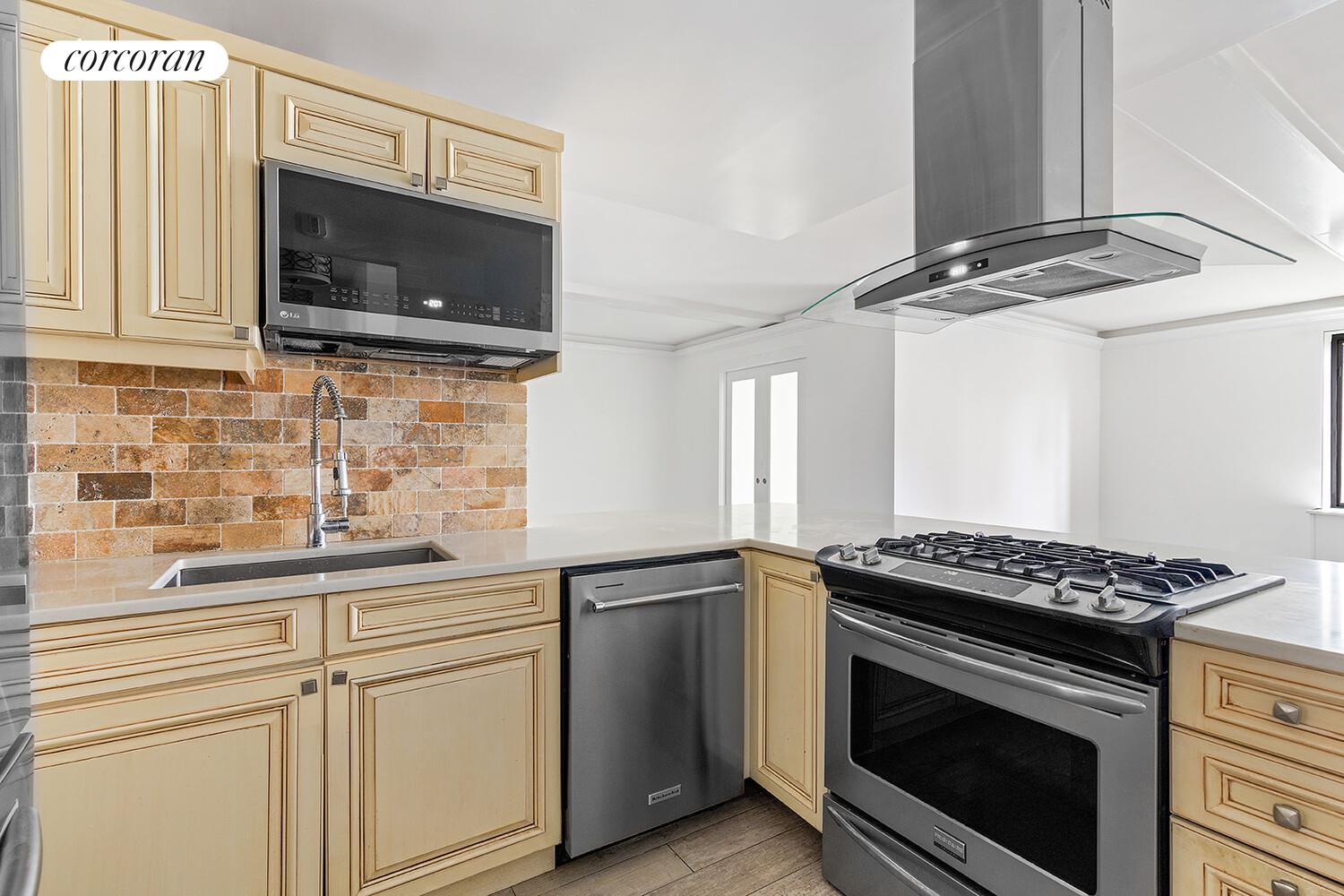 300 Rector Place, Unit 8ML Manhattan, NY 10280 - Photo 3 of 9 a kitchen with cabinets stainless steel appliances and a sink