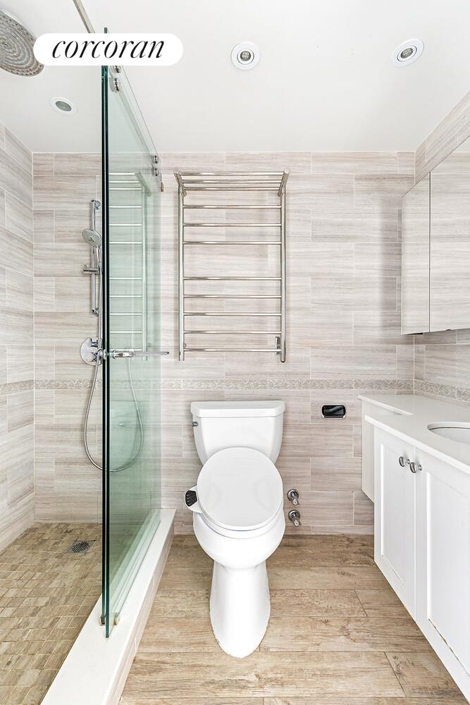 300 Rector Place, Unit 8ML Manhattan, NY 10280 - Photo 6 of 9 a bathroom with a toilet and a shower