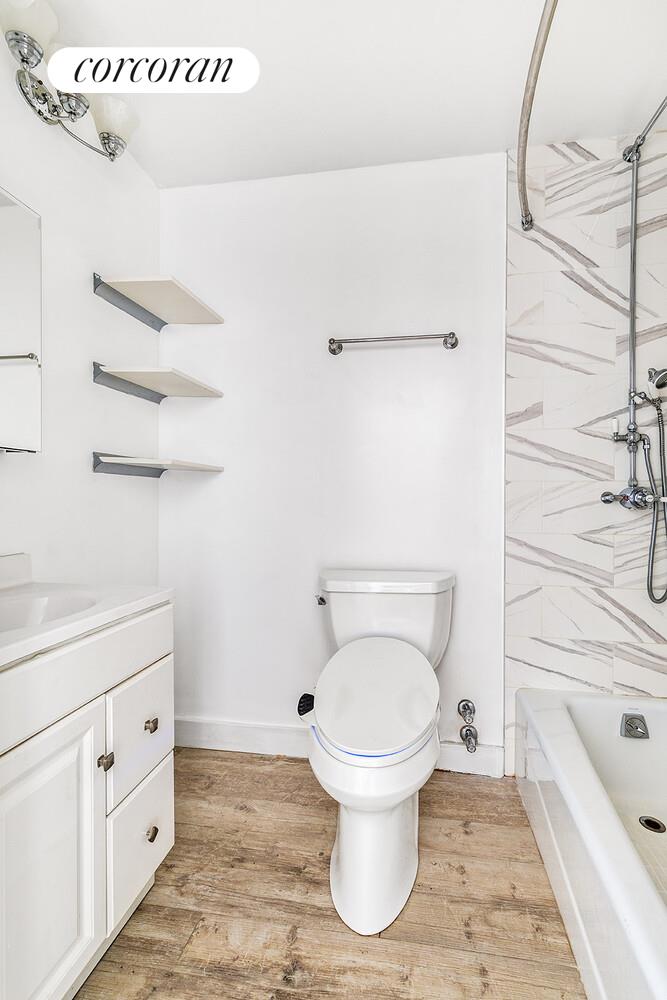 300 Rector Place, Unit 8ML Manhattan, NY 10280 - Photo 8 of 9 a bathroom with a toilet sink and mirror