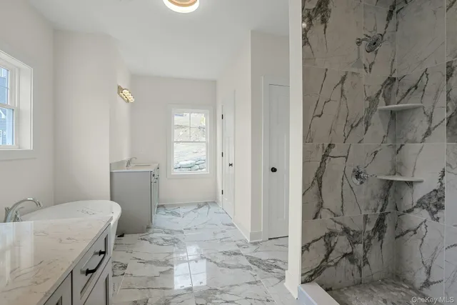 a bathroom with a granite countertop sink and a toilet
