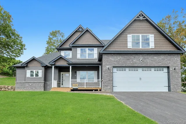 a front view of a house with a garden and yard