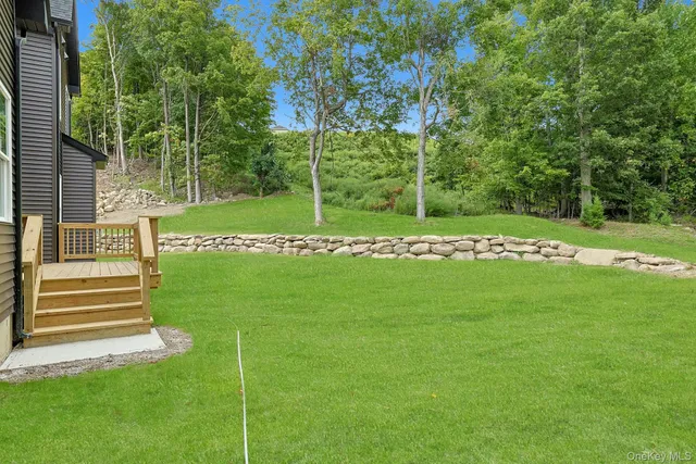 a view of a grassy field with trees